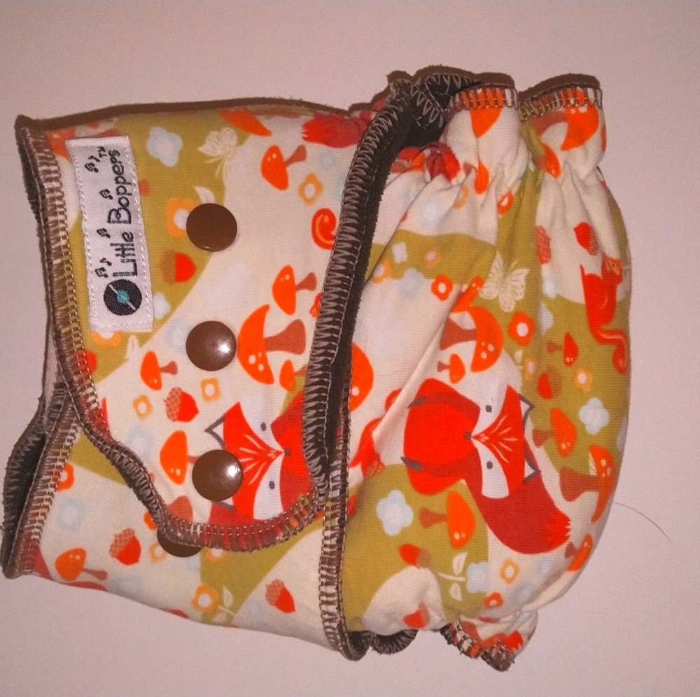 Hybrid fitted diaper